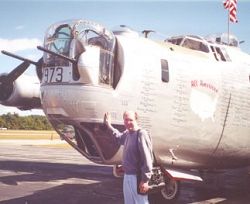 Bruce Irving poses with a restored B-24 Liberator